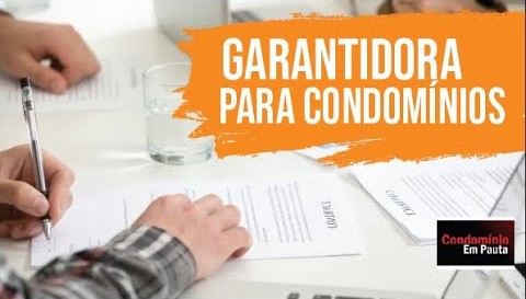 Miniatura do vídeo “Garantidora para condomínios”: mãos assinando documentos sobre a mesa e faixa laranja com o título em destaque.